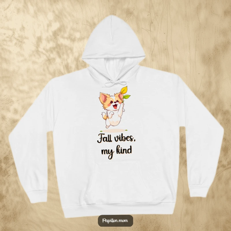 Funny Papillon dog leaping enthusiastically to catch a floating leaf, depicted on a soft, comfortable hoodie.
