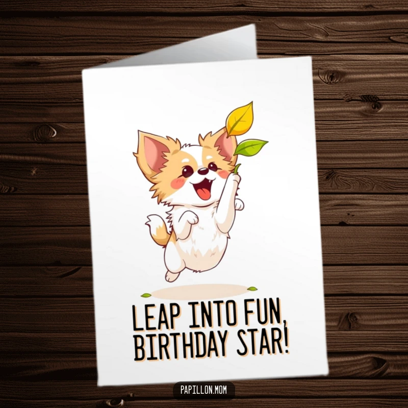 Funny Free Printable Birthday Card: A Papillon dog joyfully leaps to catch a colorful falling autumn leaf.