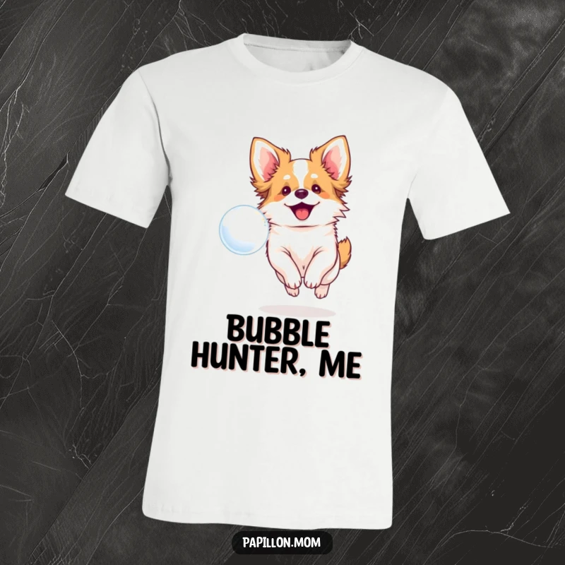 Funny t-shirt depicting a smiling Papillon dog enthusiastically chasing a floating bubble, full of canine joy.
