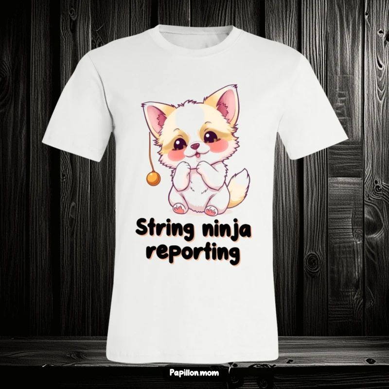 Funny Papillon t-shirt with a dog excitedly batting at a dangling string, highlighting its playful and mischievous character.